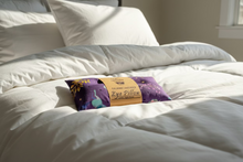 Load image into Gallery viewer, Purple eye pillow with a brown label on a white background