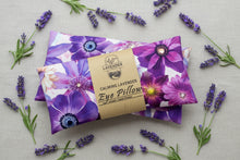 Load image into Gallery viewer, A lavender eye pillow with a purple and magenta floral print, wrapped in a kraft paper band labeled 'LAVENDER CALMING LAVENDER Eye Pillow'.
